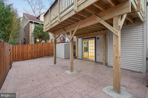 a view of a house with backyard and wooden fence