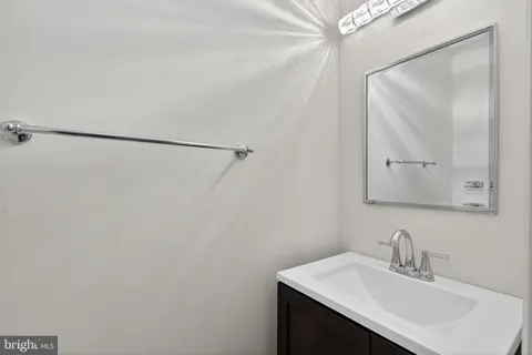 a bathroom with a sink vanity and a mirror