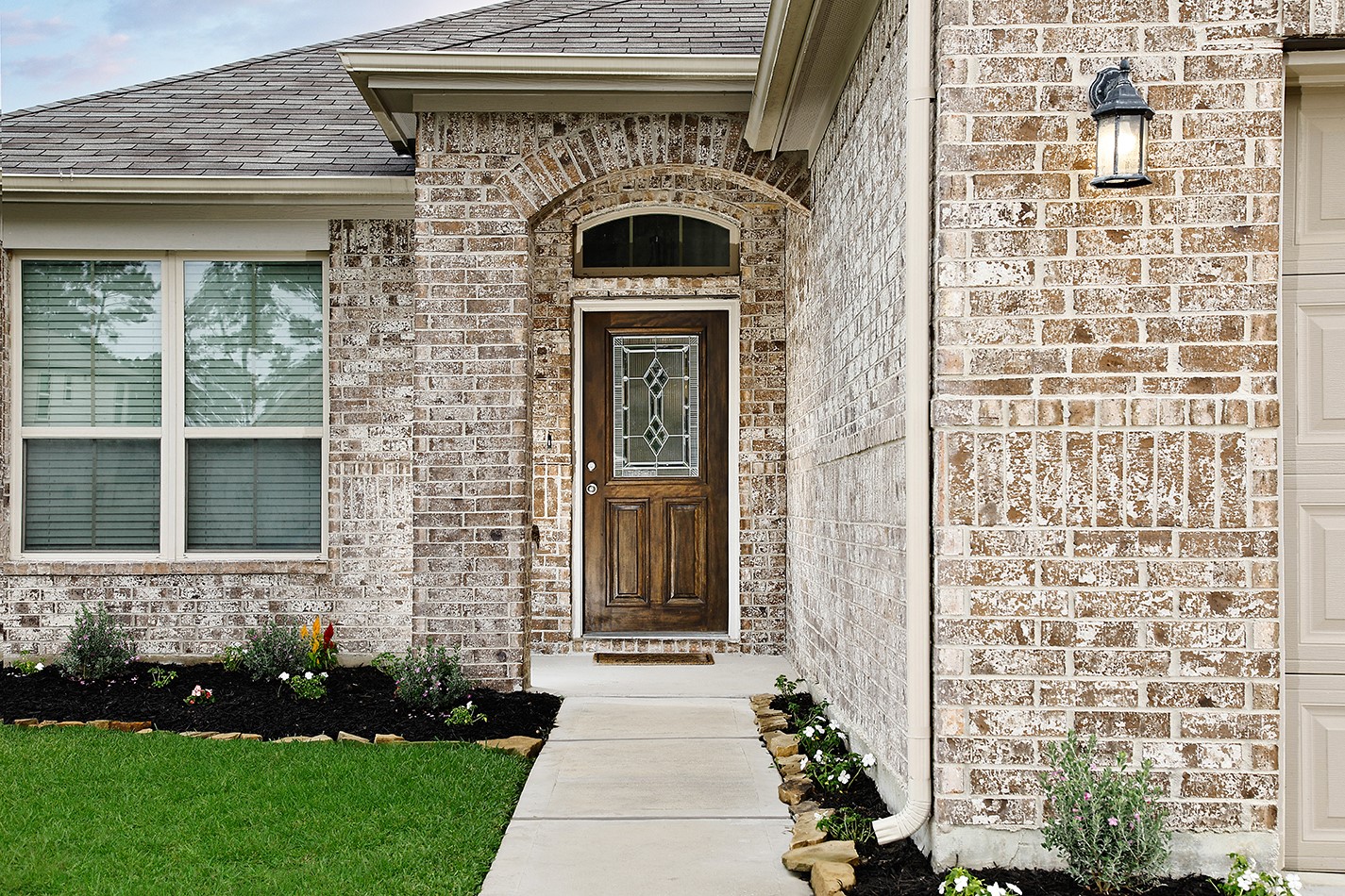 26324 Cooperstown Way Splendora, TX 77372 - Photo 2 of 23 a front view of a house with a garden