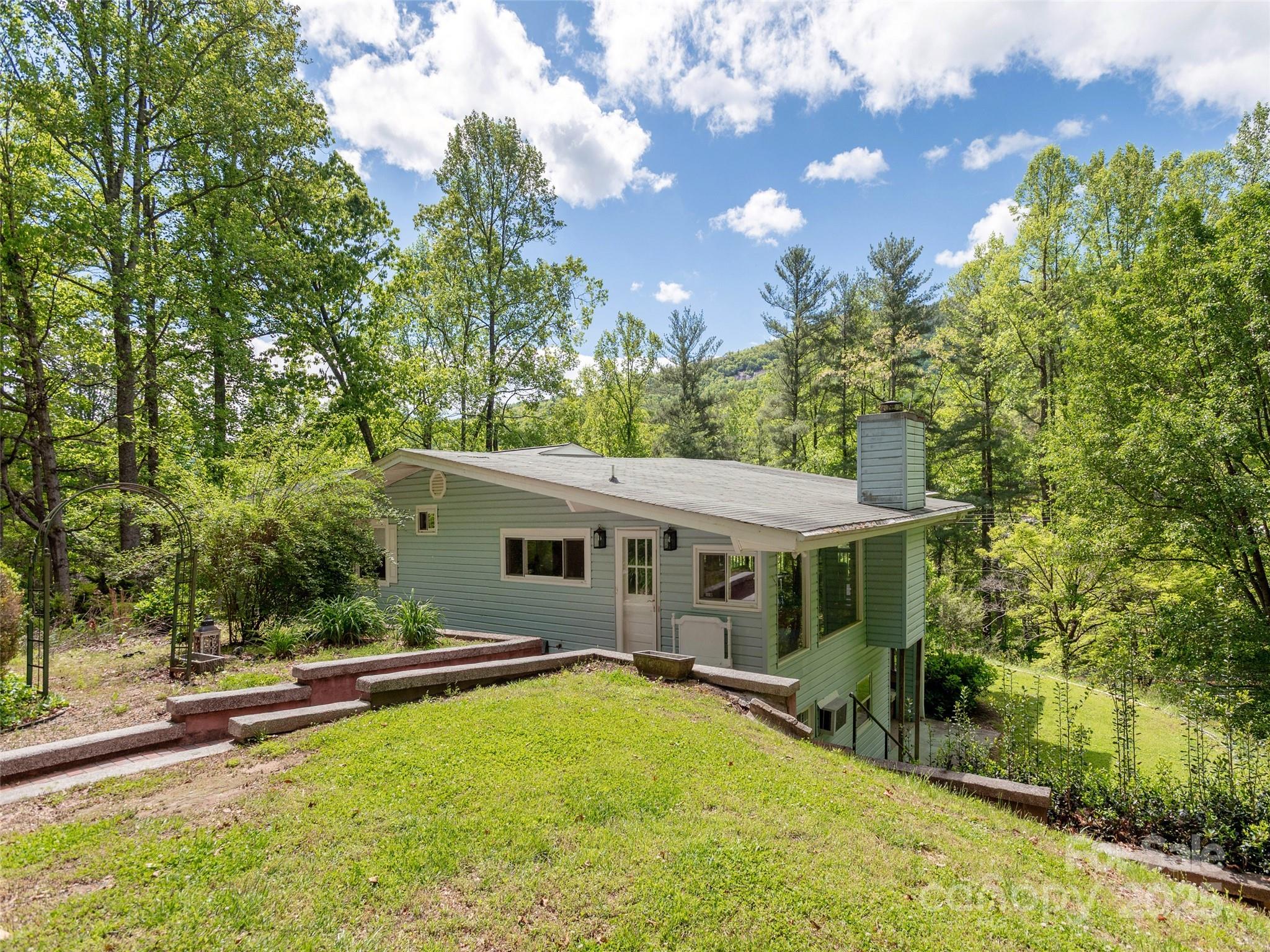 61 West Lake View Road Hendersonville, NC 28739 - Photo 1 of 37 a view of a house with swimming pool and sitting area