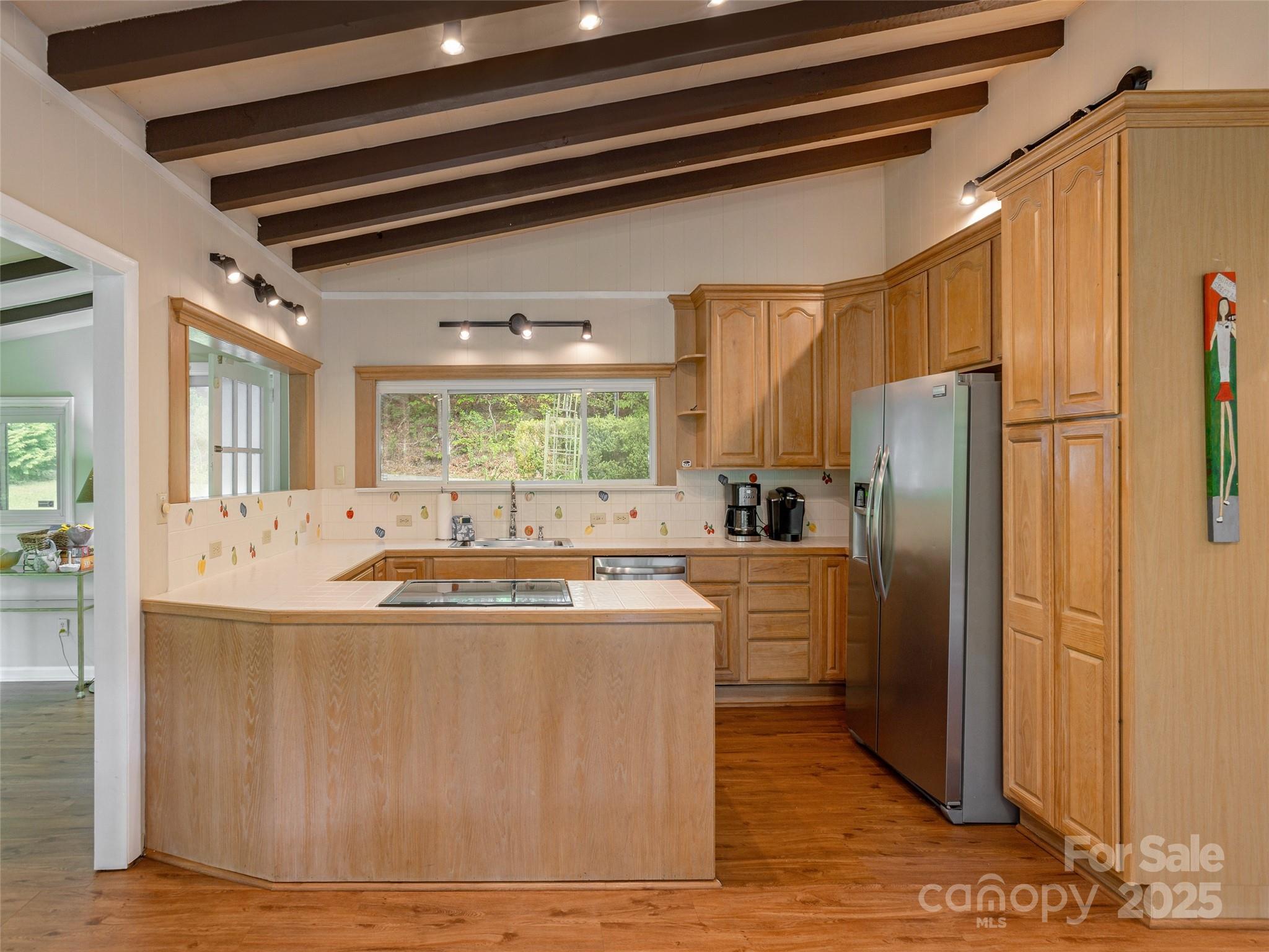 61 West Lake View Road Hendersonville, NC 28739 - Photo 14 of 37 a view of a kitchen with kitchen island a counter top space a refrigerator a sink and a window