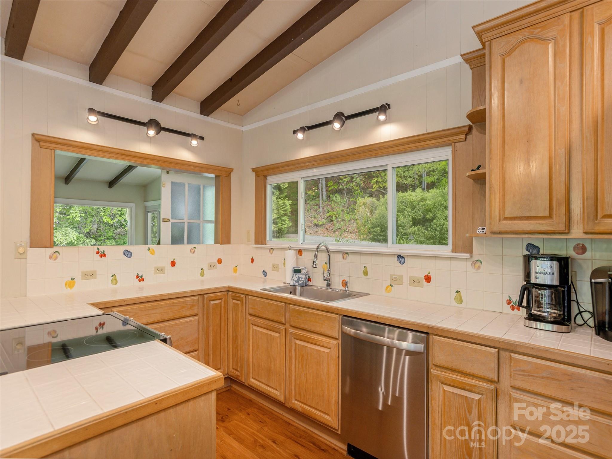 61 West Lake View Road Hendersonville, NC 28739 - Photo 16 of 37 a kitchen with sink a window and cabinets