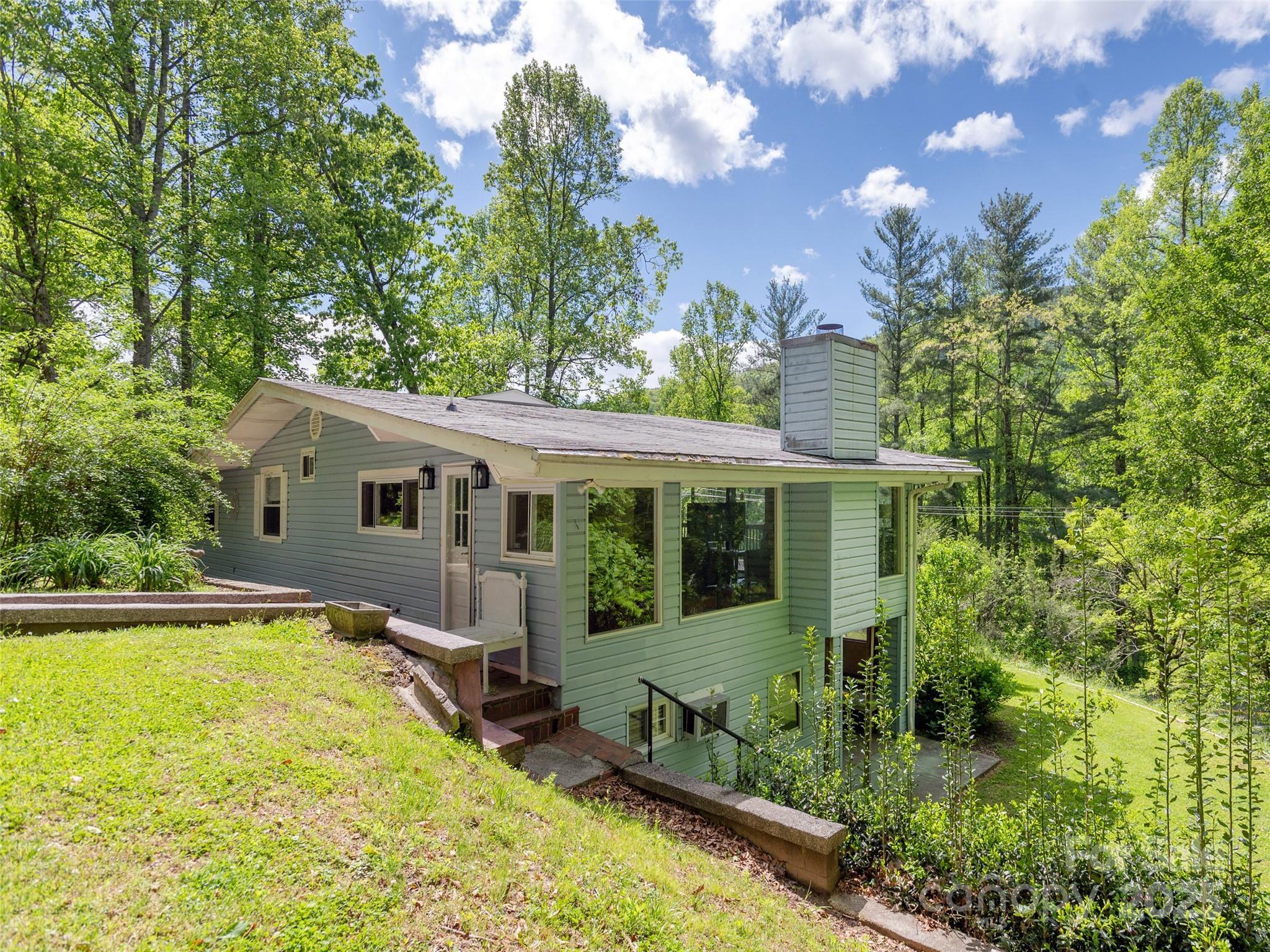 61 West Lake View Road Hendersonville, NC 28739 - Photo 2 of 37 a view of a house with pool and garden