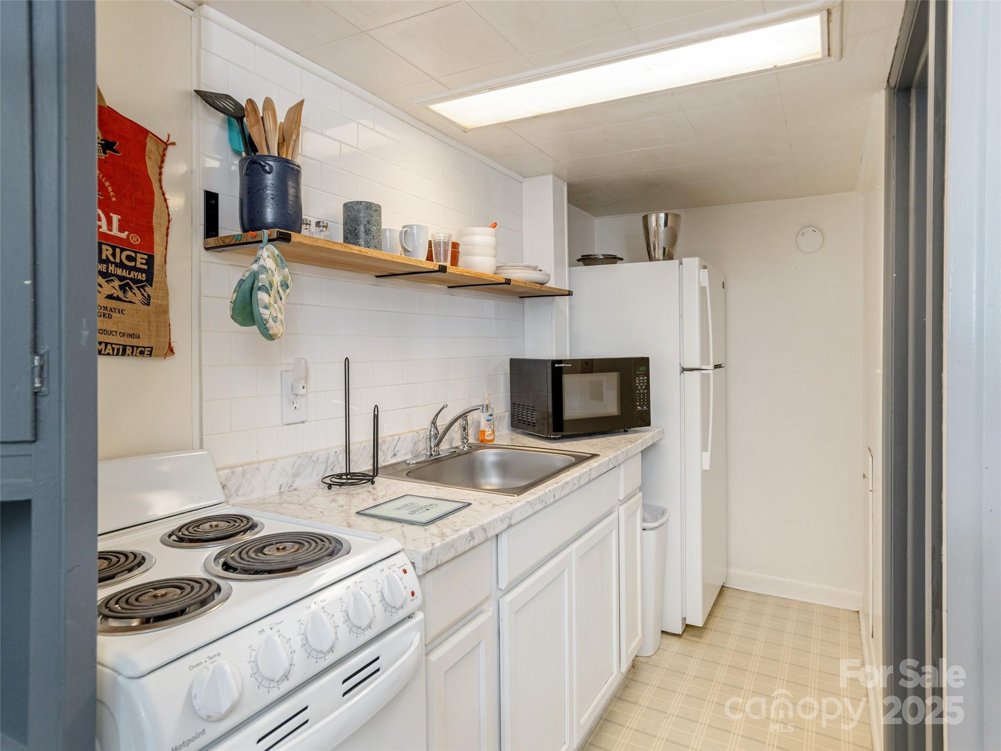 61 West Lake View Road Hendersonville, NC 28739 - Photo 27 of 37 a kitchen with stainless steel appliances a stove a sink and a refrigerator