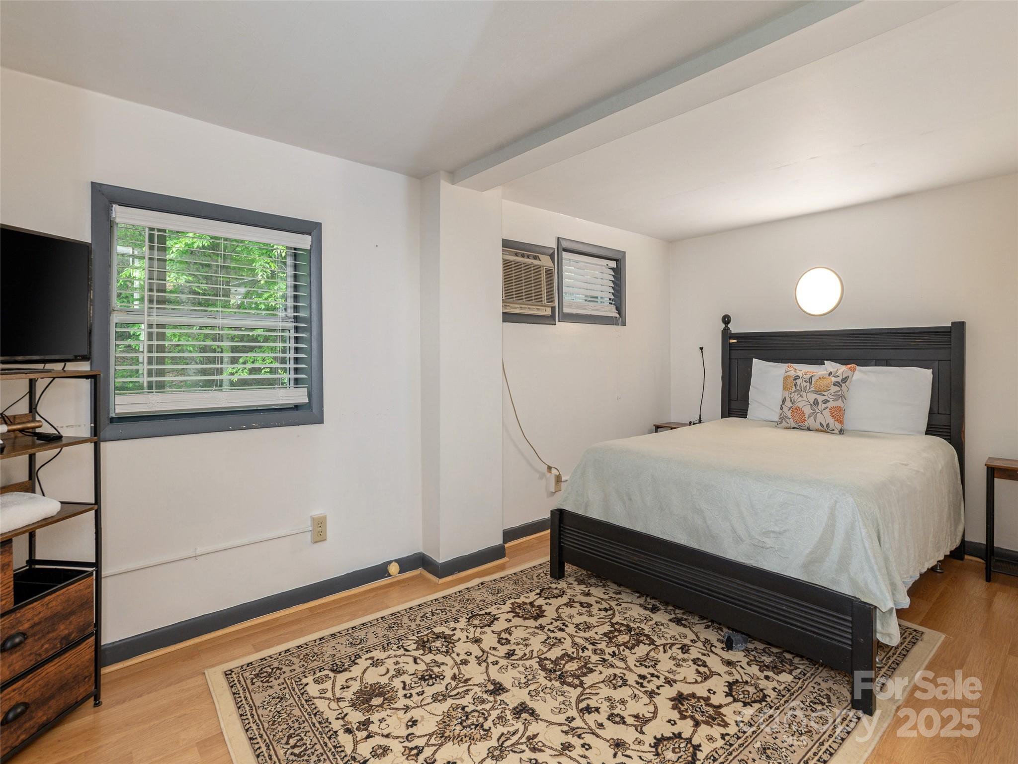 61 West Lake View Road Hendersonville, NC 28739 - Photo 29 of 37 a bedroom with a bed and a window