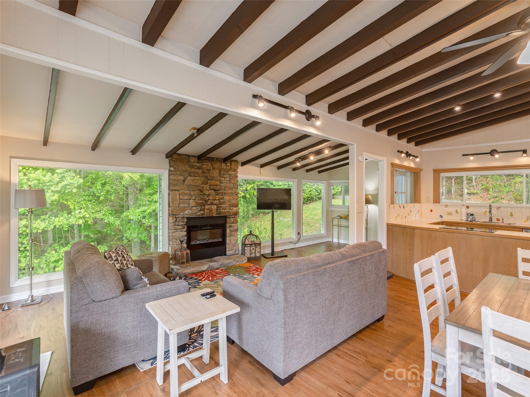 61 West Lake View Road Hendersonville, NC 28739 - Photo 8 of 37 a living room with furniture a fireplace and a table