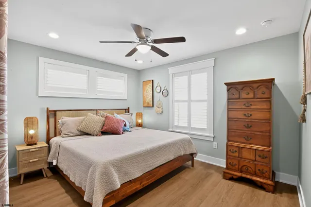 a bedroom with a bed and a ceiling fan