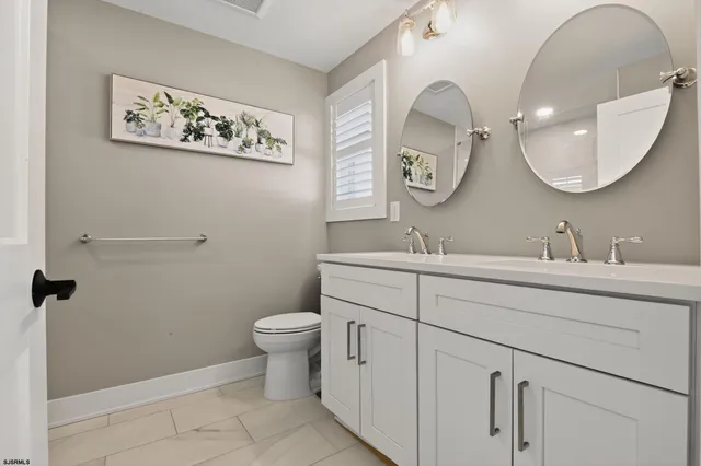 a bathroom with a toilet a sink and a mirror