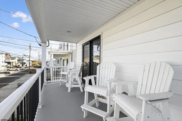 a view of a kitchen with furniture and wooden floor