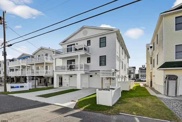 a aerial view of a white building with a yard