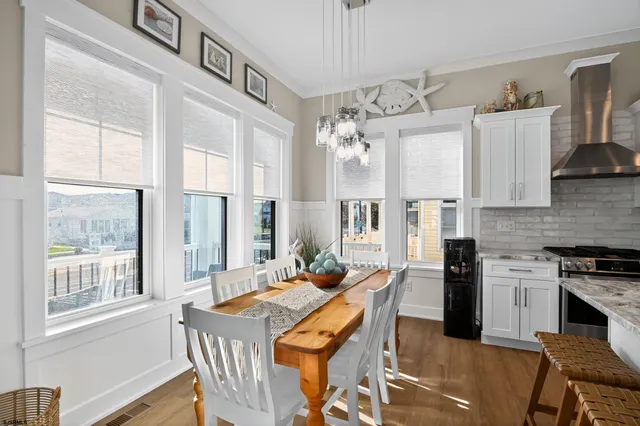 a view of a dining room with furniture and chandelier