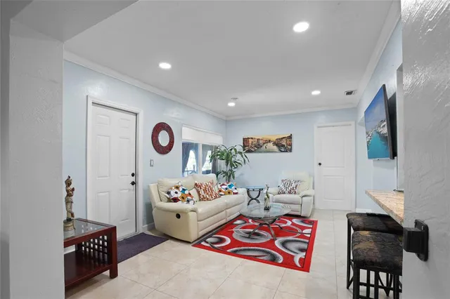 a bedroom with furniture and a flat screen tv
