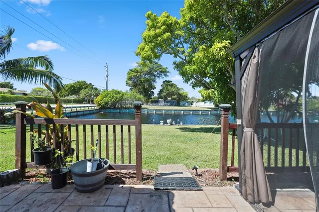 a view of a chair and tables in the patio in front of the house