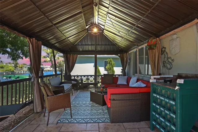 a patio with glass top table and chairs