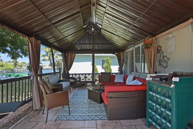 a patio with glass top table and chairs