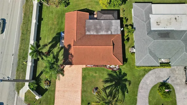 an aerial view of a house with yard