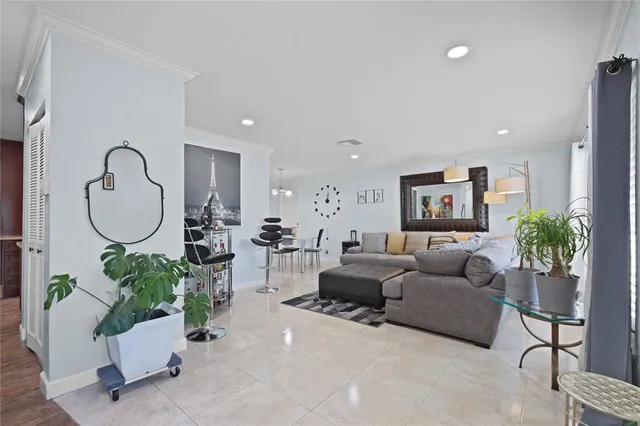 a living room with furniture potted plant and a mirror