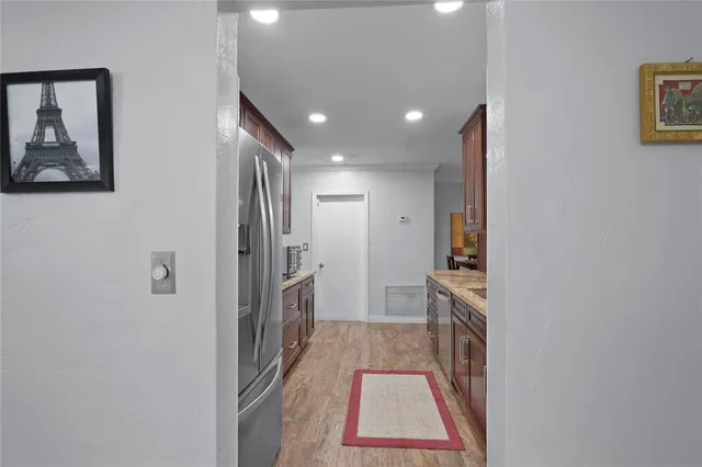 a hallway with sliding door and wooden floor