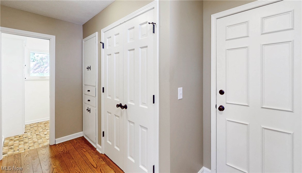 260 Sand Run Road Akron, OH 44313 - Photo 7 of 48 Doorway to outside featuring wood finished floors and baseboards