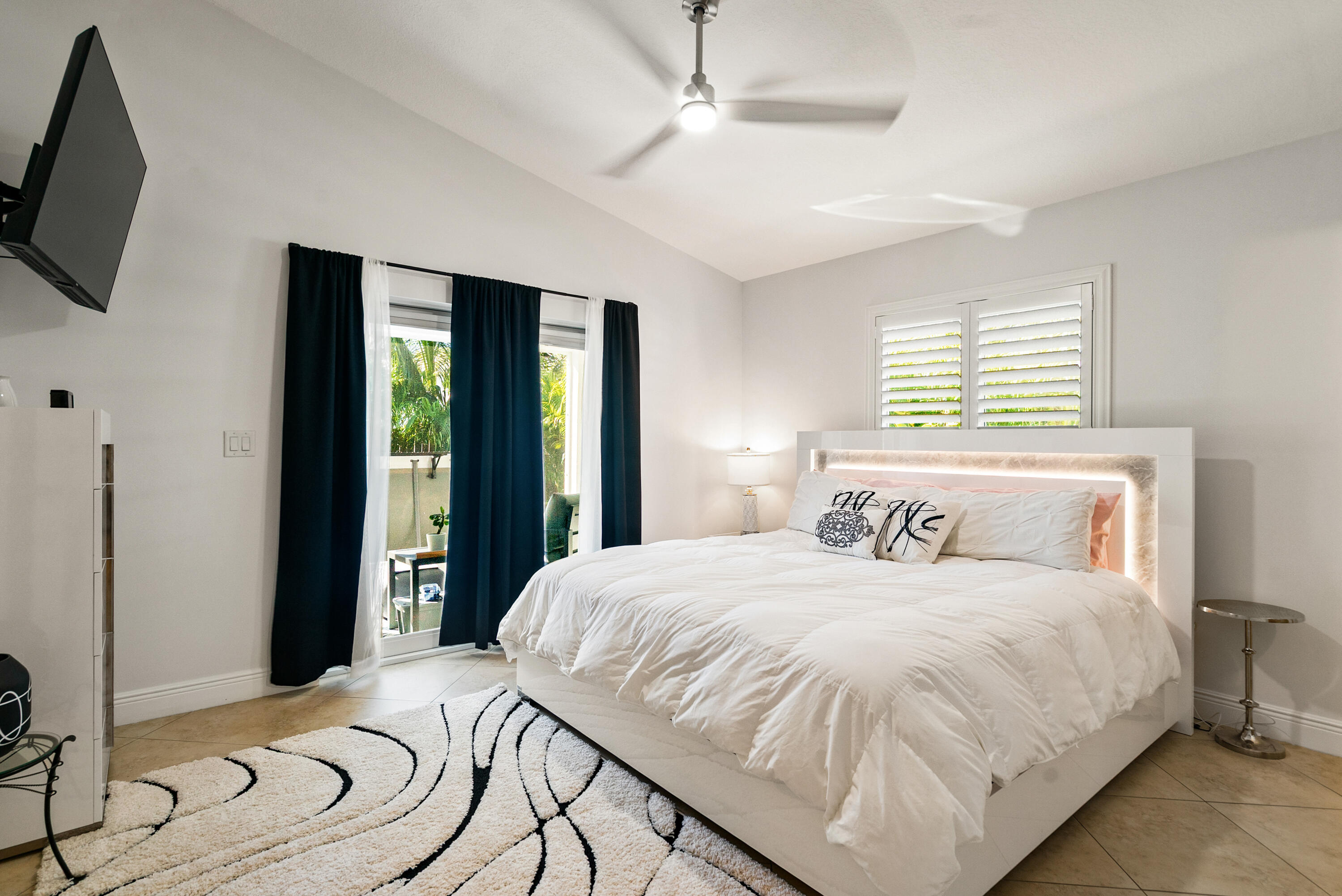 37 Bonefish Avenue Key Largo, FL 33037 - Photo 11 of 22 a bedroom with a large bed and a flat tv screen on dresser