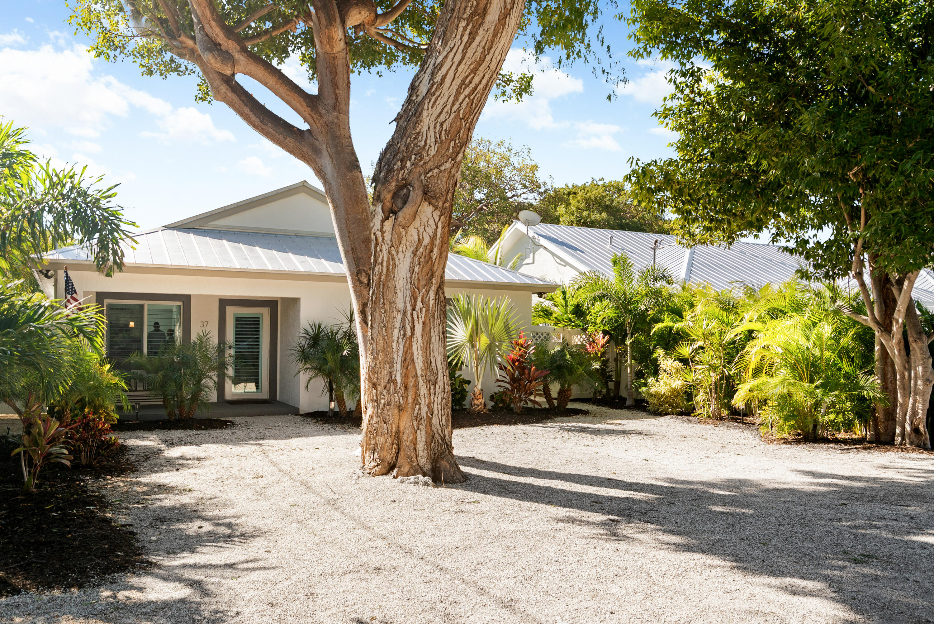 37 Bonefish Avenue Key Largo, FL 33037 - Photo 2 of 22 a view of a house with a tree in the background