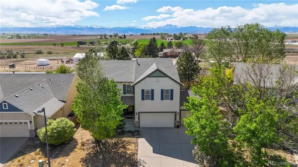 an aerial view of a house with a yard and lake view