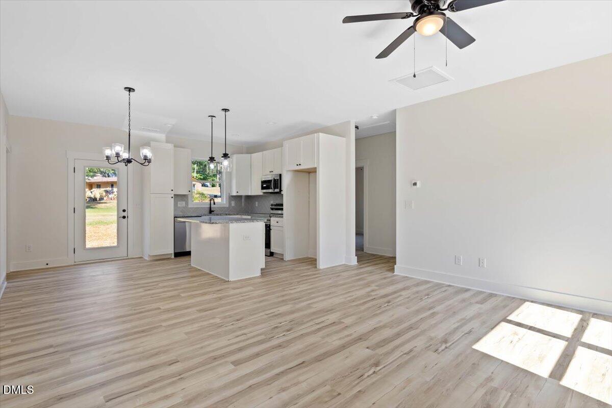 79 Theresia Lane Roxboro, NC 27574 - Photo 9 of 31 a kitchen with stainless steel appliances kitchen island a hardwood floor and a window