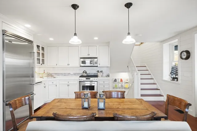 a living room with kitchen island furniture and a chandelier