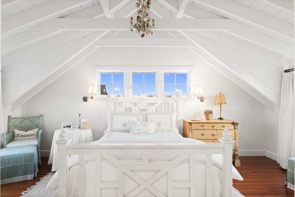 63 Baxter Road Nantucket, MA 02554 - Photo 14 of 21 a kitchen with a stove a sink dishwasher and a dining table with wooden floor