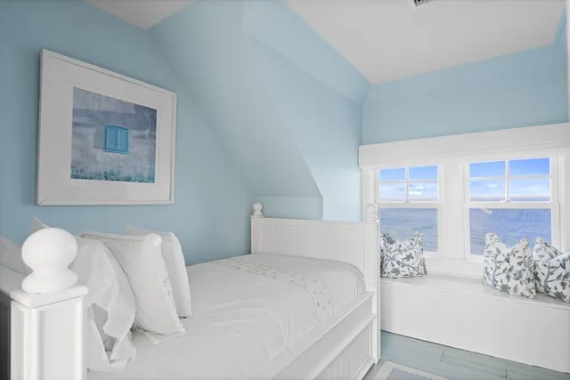 a bedroom with a large bed and a couch