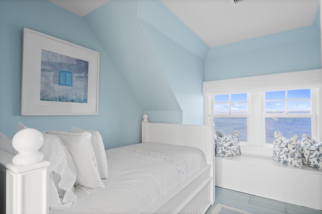 63 Baxter Road Nantucket, MA 02554 - Photo 16 of 21 a bedroom with a large bed and a couch