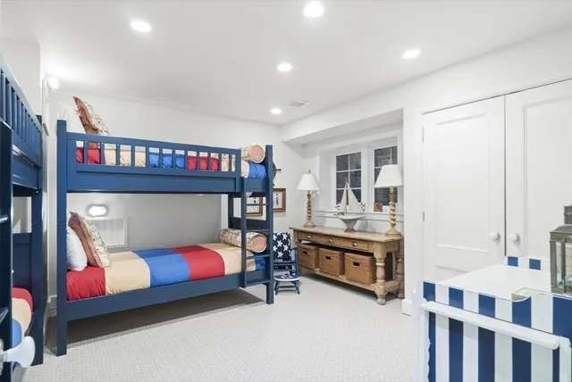 a bedroom with furniture and a large window