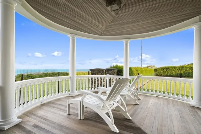 a view of a chair and tables in the balcony