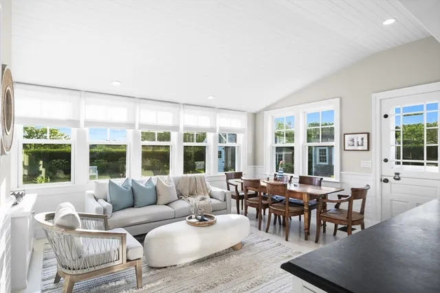 a living room with furniture and large windows
