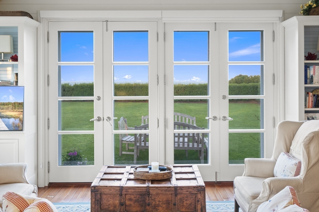 63 Baxter Road Nantucket, MA 02554 - Photo 10 of 21 a living room with hardwood floor and large windows