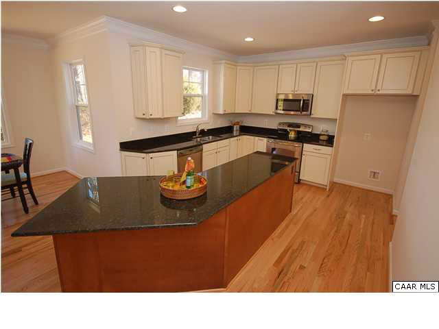 164 Wexford Ridge Road Ruckersville, VA 22968 - Photo 23 of 37 a kitchen with stainless steel appliances granite countertop a sink dishwasher a refrigerator a stove with wooden floor and cabinets