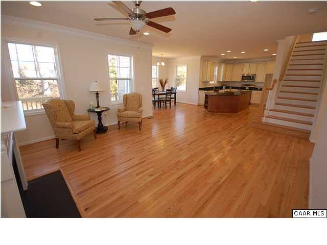 164 Wexford Ridge Road Ruckersville, VA 22968 - Photo 25 of 37 a living room with couches and kitchen view with wooden floor