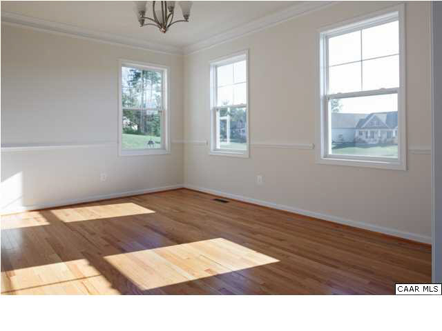 164 Wexford Ridge Road Ruckersville, VA 22968 - Photo 10 of 37 a view of an empty room with wooden floor and a window