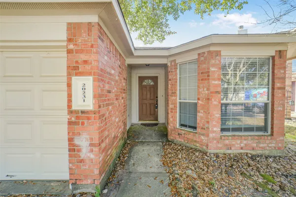 a view of a brick house with large windows