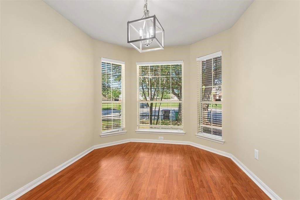 20231 Ribbonwood Point Court Tomball, TX 77375 - Photo 2 of 10 a view of an empty room with wooden floor and a window