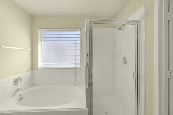 a white bath tub with a shower