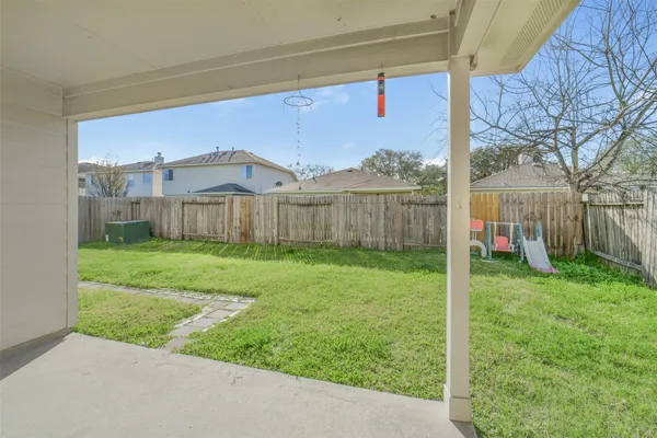 a view of a house with a yard and sitting area