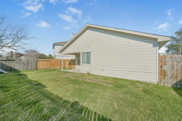 a view of a backyard with plants and a backyard
