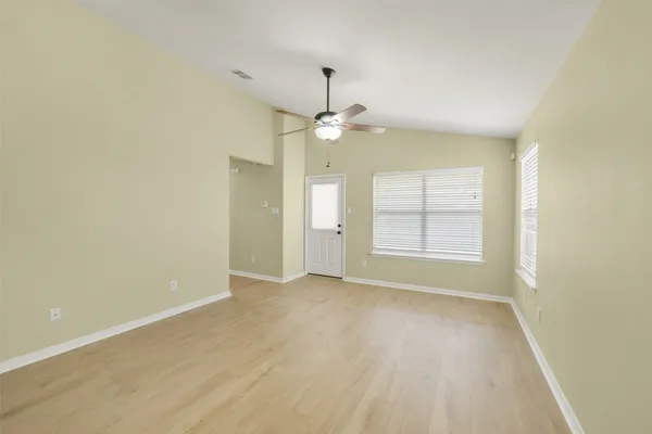 wooden floor in an empty room with a window
