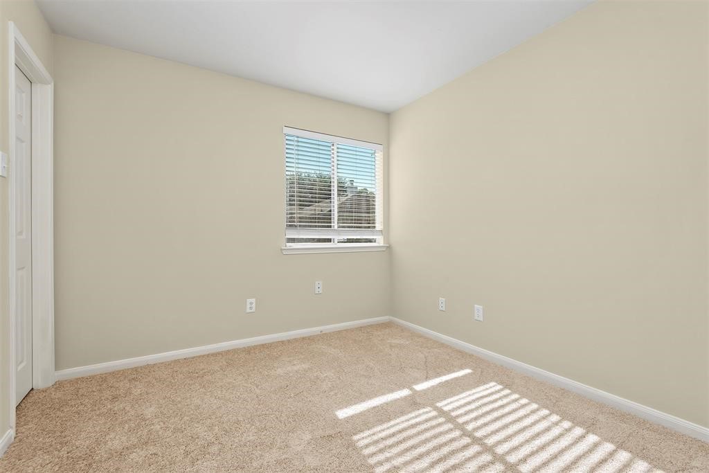 20231 Ribbonwood Point Court Tomball, TX 77375 - Photo 6 of 10 a view of an empty room with a window