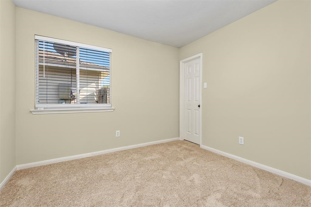20231 Ribbonwood Point Court Tomball, TX 77375 - Photo 7 of 10 a view of an empty room with a window