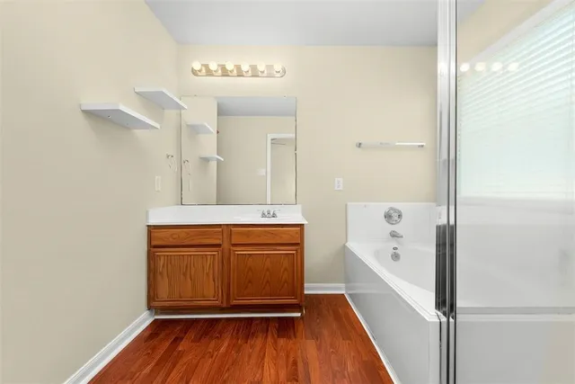 a bathroom with a sink a mirror and a bathtub