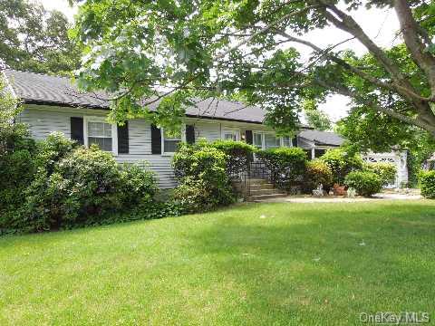 11 Jay Road Centereach, NY 11720 - Photo 1 of 1 a front view of a house with a yard and a garden