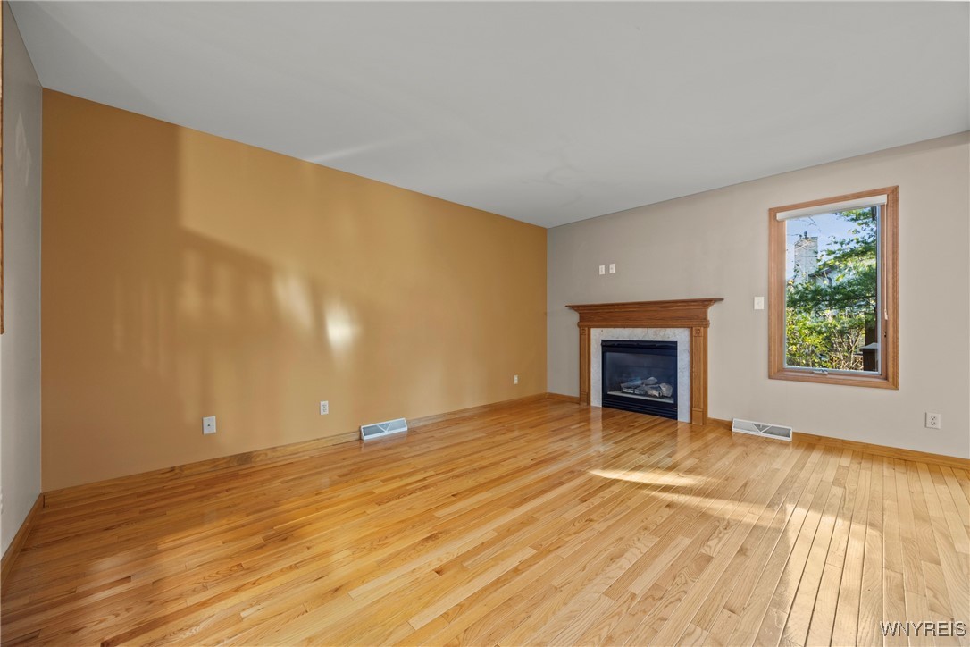 5225 Bridle Path Lane Lewiston, NY 14092 - Photo 5 of 44 bright living room with gas fireplace