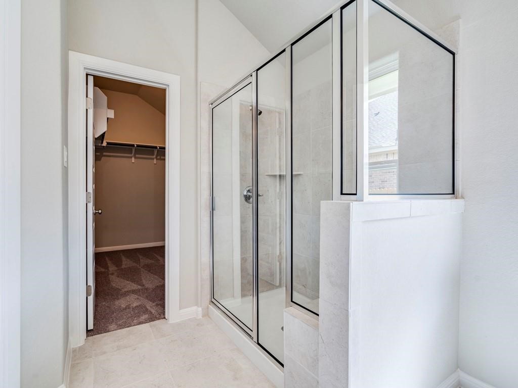 270 Rimrock Court Bastrop, TX 78602 - Photo 20 of 34 The primary suite is a true retreat, complete with a large walk-in closet, dual vanity, and walk-in shower.